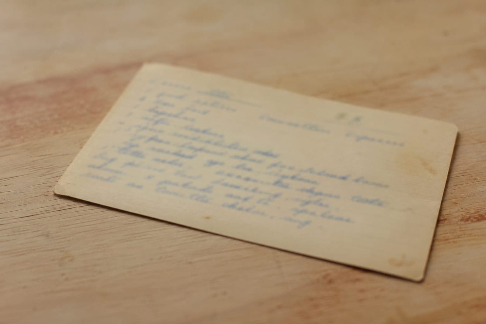 A handwritten recipe card on a kitchen table
